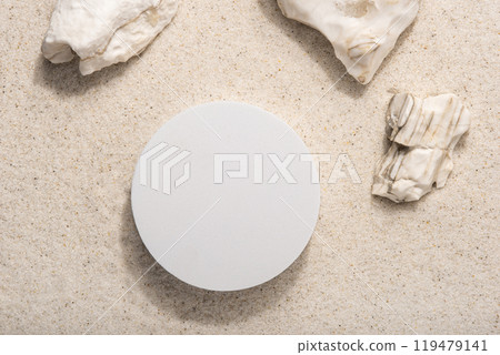 Natural cosmetic background for product presentation. Rocks and white podium on the sand. Top view. Natural cosmetic background for product presentation. Rocks and white podium on the sand. Top view. 119479141