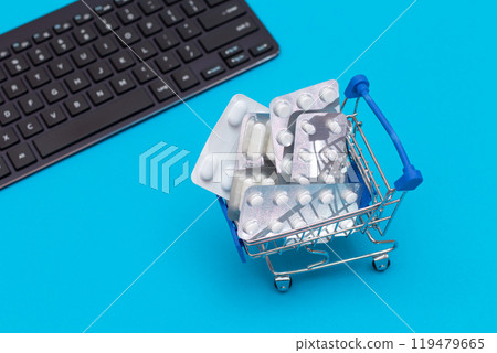 Ordering Medicines. Pills and Capsules in a Shopping Cart on Blue Background 119479665