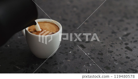 steamed milk pour into espresso steamed milk pour into espresso 119480578