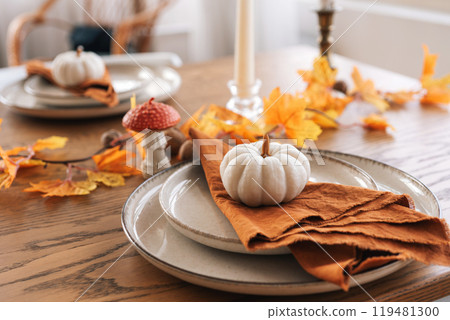 Autumn, fall, Halloween or Thanksgiving day table setting. Plates with yellow leaves and pumpkins Autumn, fall, Halloween or Thanksgiving day table setting. Plates with yellow leaves and pumpkins 119481300