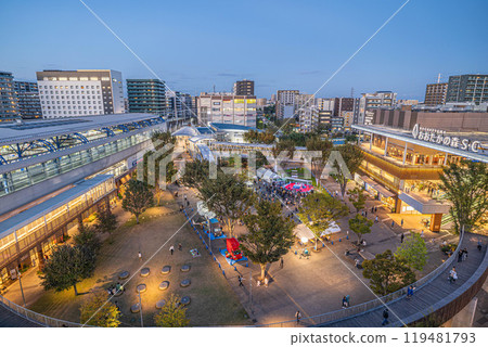 The square in front of Nagareyama Otakanomori Station is bustling with activity during a weekend event. The square in front of Nagareyama Otakanomori Station is bustling with activity during a weekend event. 119481793