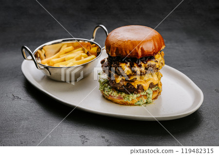 Delicious double cheeseburger with fries, perfect for fast food lovers and culinary enthusiasts Delicious double cheeseburger with fries, perfect for fast food lovers and culinary enthusiasts 119482315