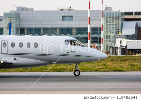 The front of private jet plane on the taxiway 119482641