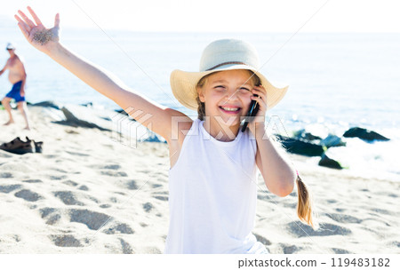 Girl talking by mobile phone on beach Girl talking by mobile phone on beach 119483182