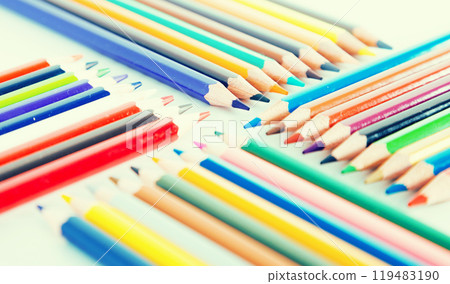 Colored pencils lying in rows 119483190