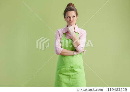 confused modern woman isolated on green confused modern woman isolated on green 119483229