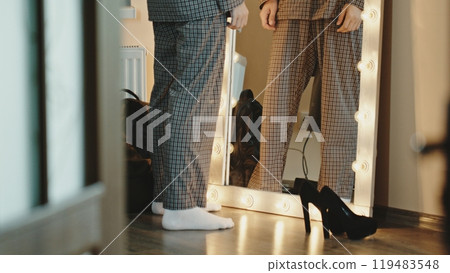 Homosexual man looking in mirror and stroking head Homosexual man looking in mirror and stroking head 119483548