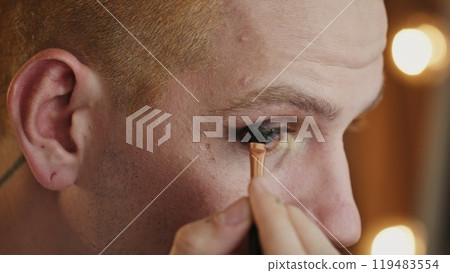 Close-Up of LGBT Individual Applying Black Eyeliner 119483554