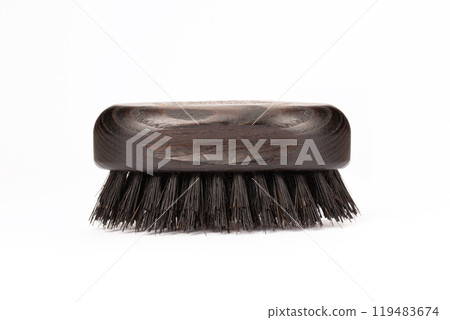 Close up view of a black wood beard brush with natural bristles on a white background in the center of the image 119483674