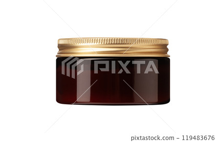 glass jar of hair grooming product for styling hair golden lid resting on the side 119483676