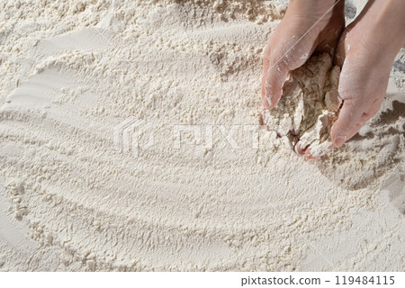 Baker working with white wheat flour, hands close-up. Baker working with white wheat flour, hands close-up. 119484115
