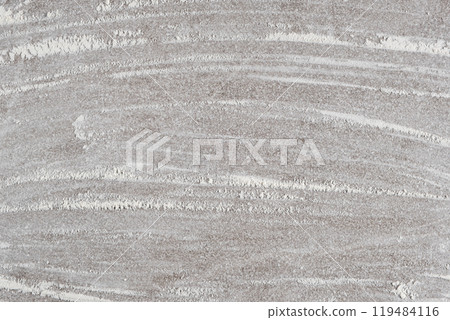 Grey cooking background of spilled wheat flour on stone background, top view. Grey cooking background of spilled wheat flour on stone background, top view. 119484116