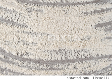 Grey cooking background of spilled wheat flour on stone background, top view. 119484117