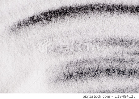 Finely ground stone white rock salt texture on black background, top view. 119484125