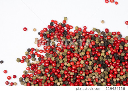 Red, green, white and black peppercorns on a white background top view. Red, green, white and black peppercorns on a white background top view. 119484136