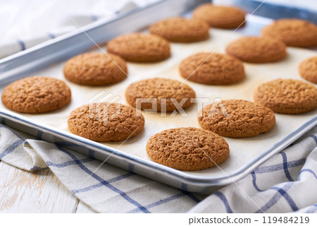 Close up of baking tray with low-calories oatmeal cookies. Close up of baking tray with low-calories oatmeal cookies. 119484219
