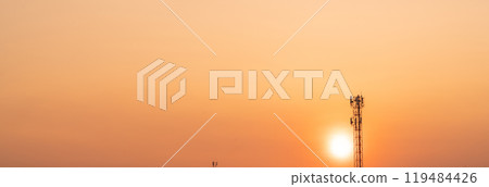 Telecommunication tower with antenna at sunset. Infrastructure of modern communication technology. 5G network connectivity and the global telecommunications industry. Wireless communication industry. 119484426