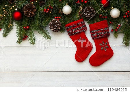 Christmas background. Christmas fir tree with decoration and red socks. Copy space, top view 119484935