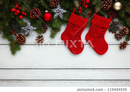Christmas background. Christmas fir tree with decoration and red socks. Copy space, top view Christmas background. Christmas fir tree with decoration and red socks. Copy space, top view 119484936