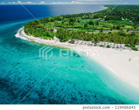 Fuvahmulah island with clear ocean, tropical beach with palms trees. Aerial view 119486845