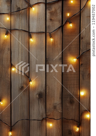 Warm string lights hanging against a rustic wooden wall create a cozy atmosphere at night Warm string lights hanging against a rustic wooden wall create a cozy atmosphere at night 119487002