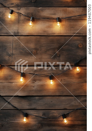 Warm string lights hanging against a rustic wooden wall create a cozy atmosphere at night Warm string lights hanging against a rustic wooden wall create a cozy atmosphere at night 119487003