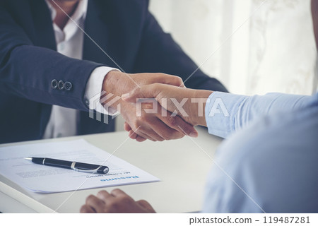 Close up hands Team Business Partners shaking hands together to Greeting Start up new project. Shakehand Teamwork Partnership office desk. Businessman partners handshake together. Business concept 119487281