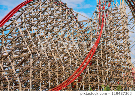 Roller coaster attraction in amusement park. Entertainment at summer holiday 119487363