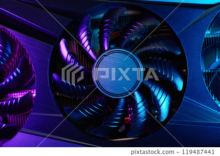 Close-up of high-performance graphics card with cooling fans illuminated by neon lighting. Modern video card for gaming and advanced computing Close-up of high-performance graphics card with cooling fans illuminated by neon lighting. Modern video card for gaming and advanced computing 119487441