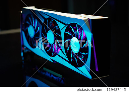 Close-up of high-performance graphics card with three cooling fans with neon lighting. Modern video card for gaming and advanced computing 119487445