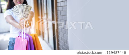 Banner Shopping bags of women crazy shopaholic person at fashion mall. Web Banner Woman love online shopping website holding shopping bags in hands with copy space. digital marketing happy lifestyle 119487446