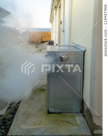 Steaming central heating boiler outside house in Ireland Steaming central heating boiler outside house in Ireland 119487466