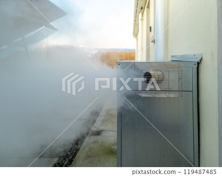 Steaming central heating boiler outside house in Ireland Steaming central heating boiler outside house in Ireland 119487485