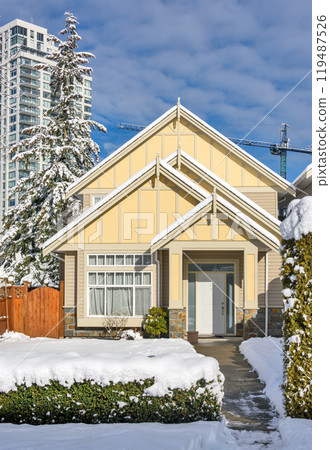 Modern high-rise and private residential house in snow on winter season Modern high-rise and private residential house in snow on winter season 119487526