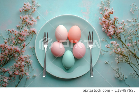 Colorful decorative Easter eggs arranged on a mint plate with cherry blossoms in springtime Colorful decorative Easter eggs arranged on a mint plate with cherry blossoms in springtime 119487653