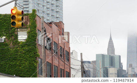 New York City street crossroad, yellow traffic light, transport road intersection, United States. 119487914