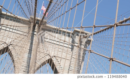 Brooklyn Bridge to Manhattan downtown, cables and blue sky. New York City iconic symbol. Travel USA. 119488040