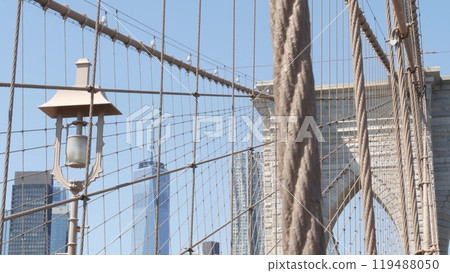 Brooklyn Bridge cables, Manhattan downtown. New York City skyline, financial district cityscape. Brooklyn Bridge cables, Manhattan downtown. New York City skyline, financial district cityscape. 119488050