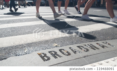 Broadway street sign, people on pedestrian zebra crossroad. New York City Manhattan road intersection Broadway street sign, people on pedestrian zebra crossroad. New York City Manhattan road intersection 119488091