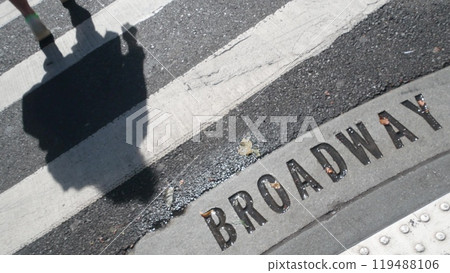 Broadway street sign, people on pedestrian zebra crossroad. New York City Manhattan road intersection 119488106