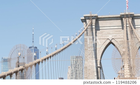 Brooklyn Bridge cables, Manhattan downtown. New York City skyline, financial district cityscape. 119488206