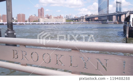 New York City skyline cityscape. Brooklyn and Manhattan Bridges, Dumbo pier railing sign. USA. 119488288