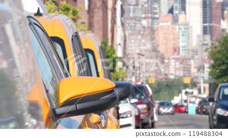 New York City. Row of yellow Taxi cars on street, Queens. Taxi cabs, Long Island. Medallion taxicab. 119488304