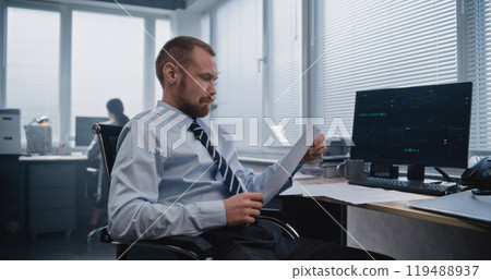 Financial manager analyzes financial reporting documents Financial manager analyzes financial reporting documents 119488937