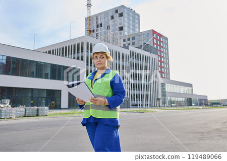 Confident mature female engineer developer inspector at construction site Confident mature female engineer developer inspector at construction site 119489066