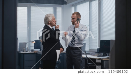 Professional stock trader speaks with business using mobile phone Professional stock trader speaks with business using mobile phone 119489102
