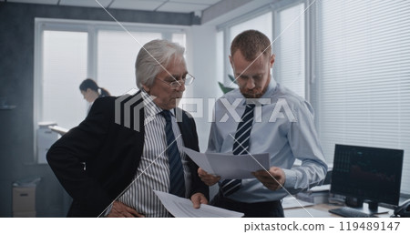 Two employees of international corporation with serious focused expression talking Two employees of international corporation with serious focused expression talking 119489147