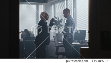 Senior team leader with papers loses temper and yells at male company employee Senior team leader with papers loses temper and yells at male company employee 119489206