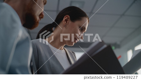 Portrait of two financial specialists studying documents, brainstorming project ideas Portrait of two financial specialists studying documents, brainstorming project ideas 119489227