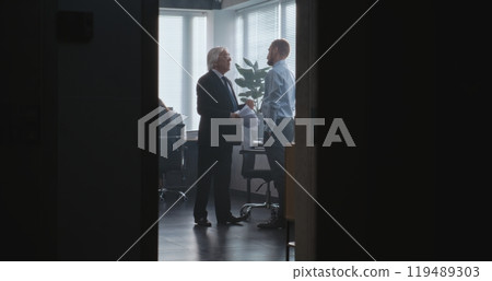 Irritated, angry team leader loses temper, yells at male employee, throws out papers 119489303